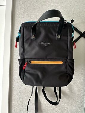 Sherpani Black Backpack with Turquoise Trim and Yellow Front Zipper